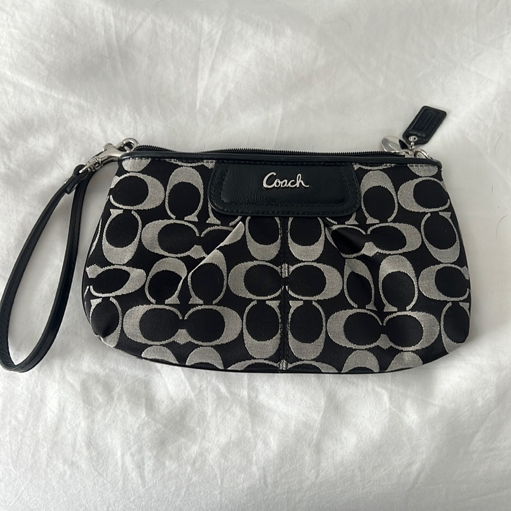 Like new Coach wristlet.  Black and grey-ish pattern. Used only once.